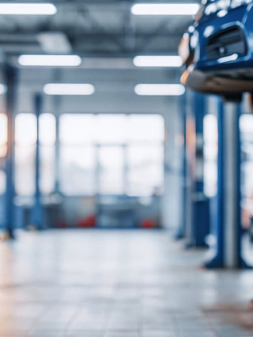 Interior del taller de R3 Motor en Lugo con vehículos sobre los elevadores